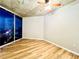 Bright bedroom features wood floors, concrete ceiling, fan, and city views through a large window at 400 W Peachtree Nw St # 2704, Atlanta, GA 30308