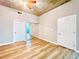 Bedroom boasts wood floors, concrete ceiling, closet, and bright views through sliding glass doors at 400 W Peachtree Nw St # 2704, Atlanta, GA 30308