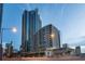 Modern high-rise building featuring balconies with views in an urban setting, street view at dusk, with clear blue skies at 400 W Peachtree Nw St # 2704, Atlanta, GA 30308