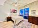 Light-filled main bedroom with hardwood floors, walk-out balcony, and room for dressers at 400 W Peachtree Nw St # 2704, Atlanta, GA 30308