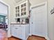 Butler's pantry with hardwood floors, white cabinets, and granite countertops at 4450 Barony Dr, Suwanee, GA 30024