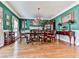 Elegant dining room with hardwood floors, a chandelier, and sophisticated green wall coverings at 4450 Barony Dr, Suwanee, GA 30024