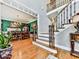 Staircase features hardwood floors, wrought iron railings and a view into the dining room at 4450 Barony Dr, Suwanee, GA 30024