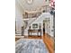 Spacious foyer with hardwood floors, a staircase with wrought iron railings, and elegant decor at 4450 Barony Dr, Suwanee, GA 30024