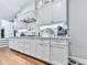 Kitchen features stainless steel appliances, white cabinets, and ample counter space at 4450 Barony Dr, Suwanee, GA 30024