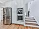 Stainless steel appliances and double ovens highlight the spacious kitchen at 4450 Barony Dr, Suwanee, GA 30024