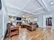 Bright living room featuring hardwood floors, beamed ceilings, built-in shelving, fireplace and comfortable seating at 4450 Barony Dr, Suwanee, GA 30024