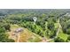 Sprawling home nestled amongst the trees with a long driveway and adjacent open lot ready for customization at 5095 Karr Road Rd, Cumming, GA 30040