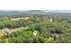 Aerial view of home surrounded by lush greenery, highlighting its serene setting and picturesque landscape at 5095 Karr Road Rd, Cumming, GA 30040