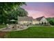 Backyard featuring a pool, patio, and fire pit at dusk with a beautiful pink sky at 5095 Karr Road Rd, Cumming, GA 30040
