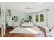 Bright bedroom features light blue walls, hardwood floors, and a sunlit window at 5095 Karr Road Rd, Cumming, GA 30040