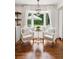 Inviting breakfast nook features a built-in bench with white cushions and tranquil backyard views at 5095 Karr Road Rd, Cumming, GA 30040