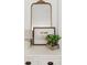 Stylish decor featuring a vintage mirror, a framed quote, and charming greenery on a white dresser at 5095 Karr Road Rd, Cumming, GA 30040
