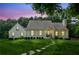 Charming one story home featuring a well-manicured lawn, brick pathway and lush greenery at 5095 Karr Road Rd, Cumming, GA 30040