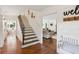 Bright foyer with hardwood floors, a staircase, and a view into the living room at 5095 Karr Road Rd, Cumming, GA 30040