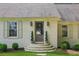 Elegant front entrance with brick steps, a classic wooden door, and stylish outdoor sconces at 5095 Karr Road Rd, Cumming, GA 30040