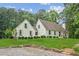 Inviting home showcasing a lush front lawn and a quaint stone retaining wall, enhancing curb appeal at 5095 Karr Road Rd, Cumming, GA 30040