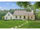 Charming home featuring a beautifully landscaped front yard and inviting stone pathway to the front door at 5095 Karr Road Rd, Cumming, GA 30040