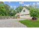 Charming home with a three-car garage, gravel driveway, and fenced yard at 5095 Karr Road Rd, Cumming, GA 30040