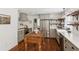 Well-appointed kitchen features stainless steel appliances, gray cabinetry, and a rustic wood island centerpiece at 5095 Karr Road Rd, Cumming, GA 30040