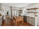 Charming kitchen with stainless steel appliances, open shelving, farmhouse sink, and a rustic wood island at 5095 Karr Road Rd, Cumming, GA 30040