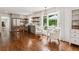 Wide-open kitchen flowing into a breakfast nook, showcasing stainless appliances and beautiful hardwood floors at 5095 Karr Road Rd, Cumming, GA 30040