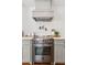 A kitchen oven with a stainless steel range, gray cabinets, and a pot filler faucet at 5095 Karr Road Rd, Cumming, GA 30040