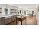 Bright, open kitchen with a farmhouse sink, stainless steel appliances, open shelving, and a wood island at 5095 Karr Road Rd, Cumming, GA 30040