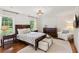 Comfortable main bedroom with a large bed, hardwood floors, and lots of natural light at 5095 Karr Road Rd, Cumming, GA 30040