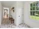 Bright mudroom with herringbone brick floors, coat hooks and built in bench at 5095 Karr Road Rd, Cumming, GA 30040
