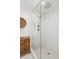 Shower area with sleek glass door, white subway tile walls, and penny tile flooring at 5095 Karr Road Rd, Cumming, GA 30040