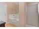 Bathroom with a white tub, shower, and a window that offers natural light at 5865 El Segundo Way, Atlanta, GA 30349