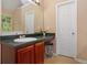 Well-lit bathroom featuring a vanity with a dark countertop and ample storage space at 5865 El Segundo Way, Atlanta, GA 30349