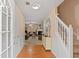 Inviting foyer with hardwood floors, staircase, and views of the living area; the space is brightly lit with natural light at 5865 El Segundo Way, Atlanta, GA 30349