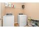 Functional laundry room with modern washer, dryer, and convenient shelving for supplies at 5865 El Segundo Way, Atlanta, GA 30349