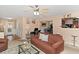 Spacious living area featuring a ceiling fan, carpet flooring, and seamless flow to the dining area at 5865 El Segundo Way, Atlanta, GA 30349