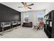 Modern bedroom with dark accent wall, stylish seating, and abundant natural light at 113 Poppy St, Mcdonough, GA 30253