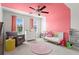 Cheerful bedroom with colorful accents, ample natural light, and cozy seating area at 113 Poppy St, Mcdonough, GA 30253
