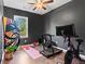 Exercise room with dark walls and ceiling fan, equipped with treadmill and bike at 113 Poppy St, Mcdonough, GA 30253
