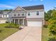 Beautiful two-story home with a well-maintained lawn, an attached two-car garage, and classic architectural details at 113 Poppy St, Mcdonough, GA 30253