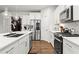 Well-equipped kitchen featuring stainless steel appliances, white cabinets, a functional layout, and hardwood flooring at 113 Poppy St, Mcdonough, GA 30253