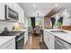 Contemporary kitchen featuring stainless steel appliances, a kitchen island, and hardwood floors at 113 Poppy St, Mcdonough, GA 30253