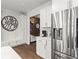 Modern kitchen with white cabinetry, stainless steel refrigerator, and hardwood flooring at 113 Poppy St, Mcdonough, GA 30253