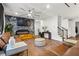 Spacious living room featuring modern fireplace, stylish sofas, and hardwood floors at 113 Poppy St, Mcdonough, GA 30253