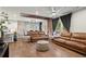 Open-concept living room and kitchen area with hardwood flooring and stylish furnishings at 113 Poppy St, Mcdonough, GA 30253