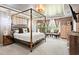 Elegant main bedroom suite featuring a four-poster bed, accent lighting, and seating area at 113 Poppy St, Mcdonough, GA 30253