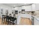Modern kitchen featuring white cabinets, granite countertops, stainless steel appliances, and a center island with barstool seating at 817 Dobby Way, Mcdonough, GA 30252