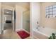 Bright bathroom with a soaking tub, glass shower, tile floor and view to bedroom at 8484 Glenview St, Douglasville, GA 30134