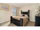 A charming bedroom featuring a dark bed frame, neutral carpet, and ample natural light at 8484 Glenview St, Douglasville, GA 30134