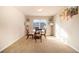 A cozy dining area featuring carpeted floors, a modern light fixture, and natural light at 8484 Glenview St, Douglasville, GA 30134